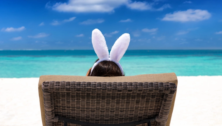 Wielkanoc 2026 za granicą, kobieta patrzy na błękitny ocean